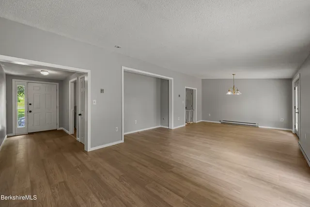 a view of a livingroom with wooden floor and a window