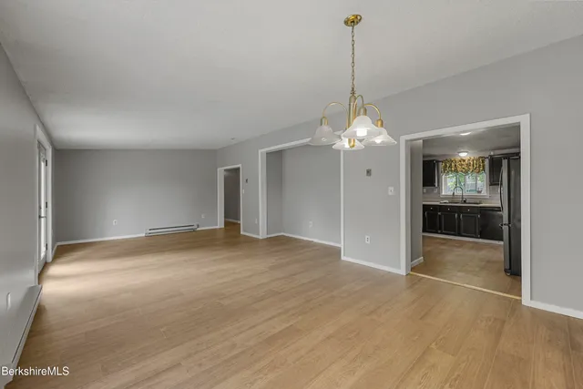 a view of a room window and wooden floor