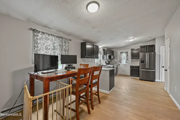a view of a dining room with furniture and a fireplace