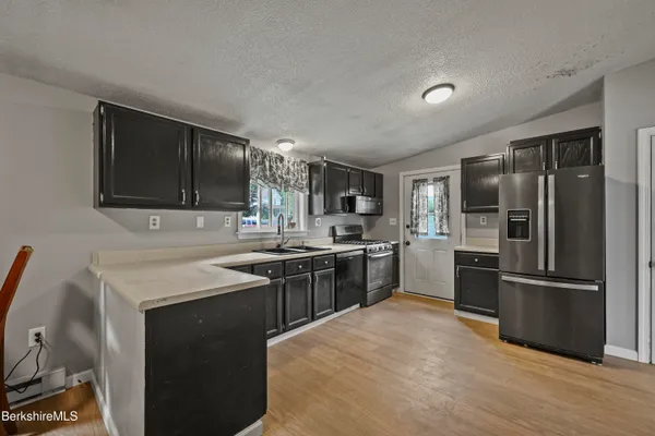 a kitchen with a sink stove and refrigerator