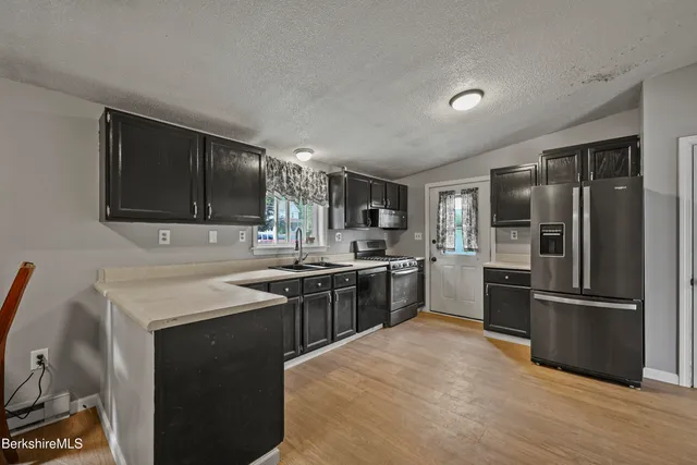 a kitchen with a sink stove and refrigerator