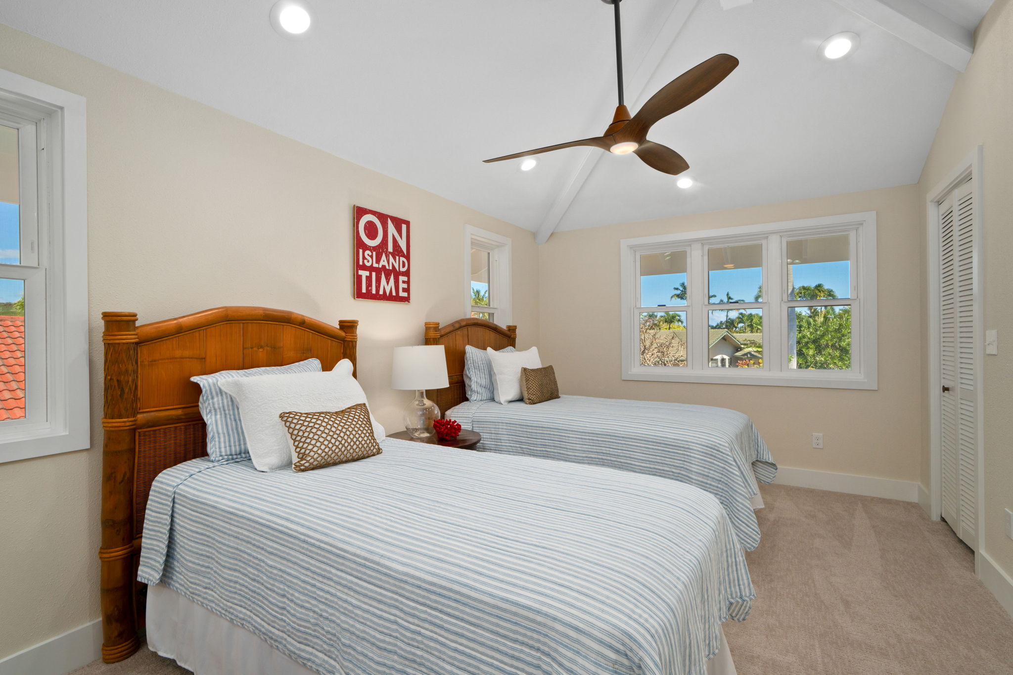 1753 Kelaukia Street Koloa, HI 96756 - Photo 24 of 27 a bedroom with a bed and a large window