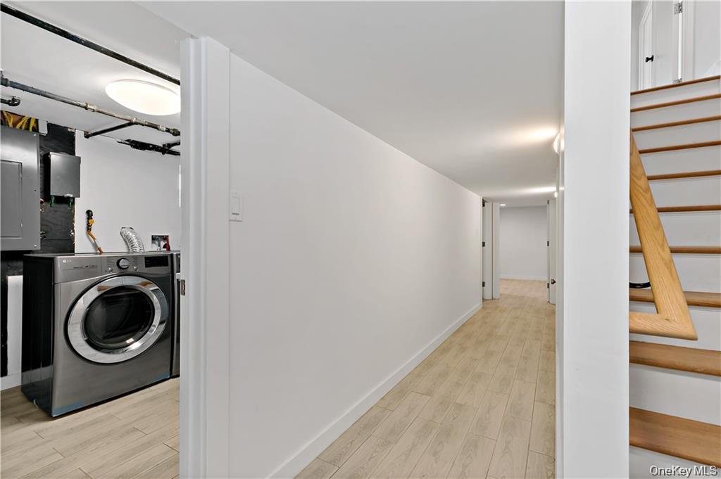 9 Lyons Place New Rochelle, NY 10801 - Photo 15 of 20 Laundry room with washer / clothes dryer, electric panel, and light wood finished floors