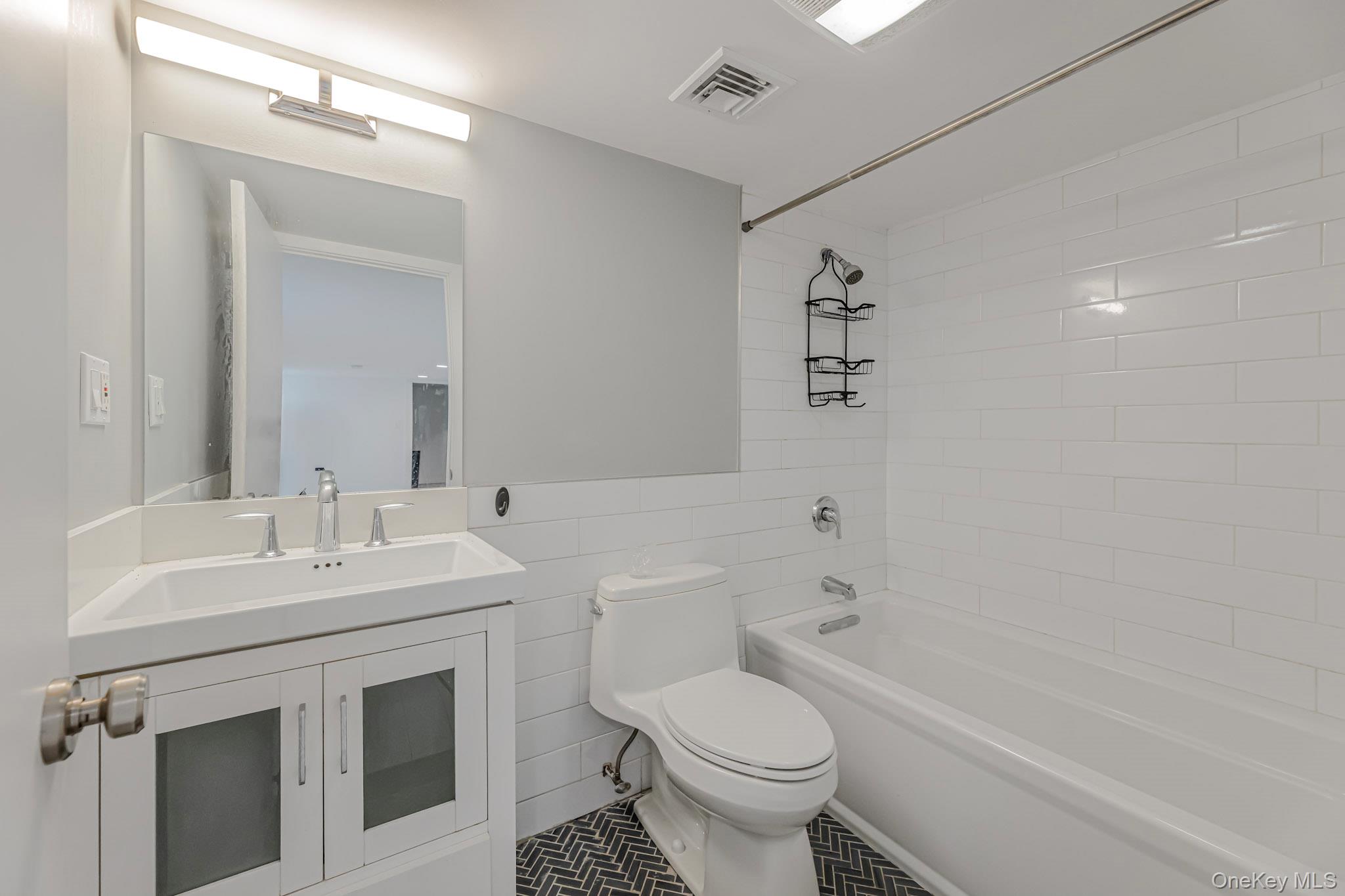 9 Lyons Place New Rochelle, NY 10801 - Photo 9 of 20 Bathroom with bathing tub / shower combination, tile walls, and vanity