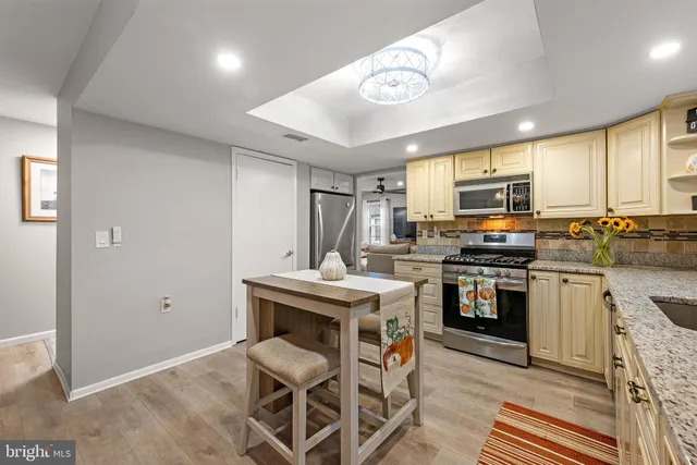 a kitchen with cabinets a sink and appliances