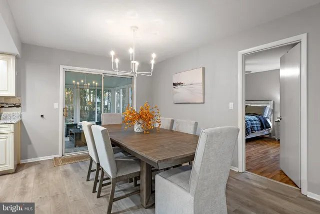 a view of a dining room with furniture and a chandelier