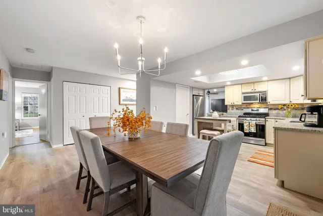 a view of a dining room and livingroom view kitchen and a chandelier