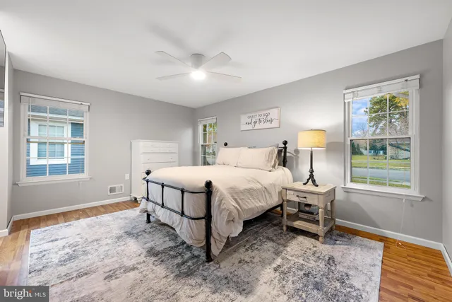 a spacious bedroom with a bed and a window