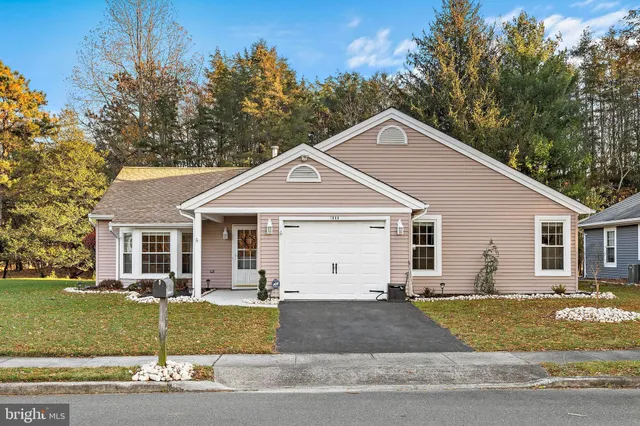 a view of a yard in front of a house with garage