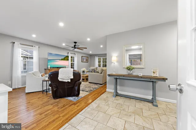 a living room with furniture a dining table and wooden floor