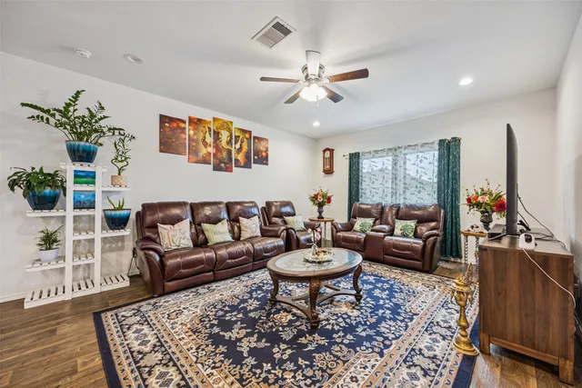 a living room with furniture a rug and a flat screen tv