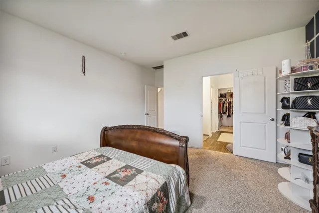 a bedroom with a bed and a chair