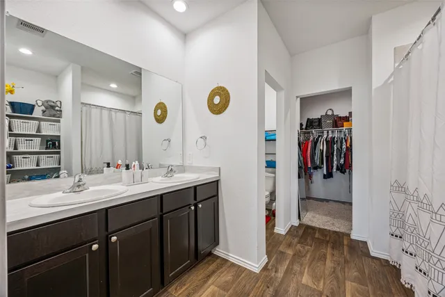 a bathroom with a sink a light fixture and a mirror