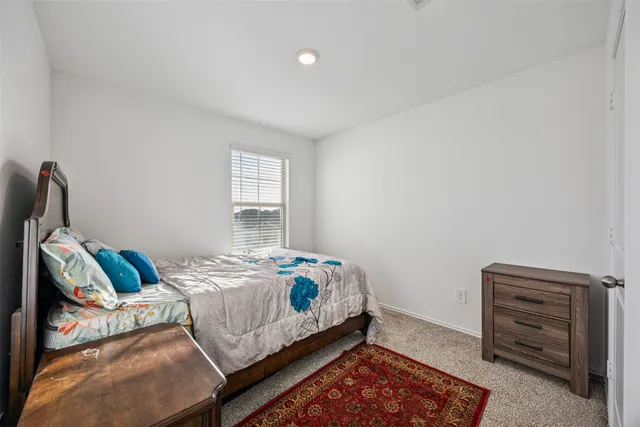 a bedroom with a bed and with furniture