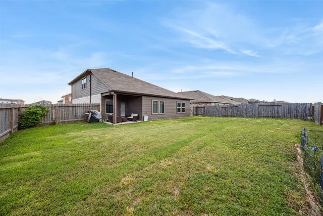 a view of a house with a backyard