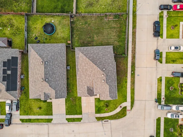aerial view of a brick house with a street sign and a potted plant