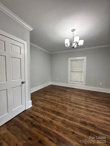 a large kitchen with cabinets wooden floor stainless steel appliances and window