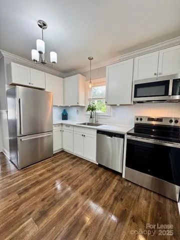 a kitchen with stainless steel appliances a refrigerator sink and cabinets