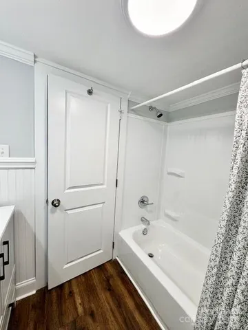 a bathroom with a bathtub and a shower