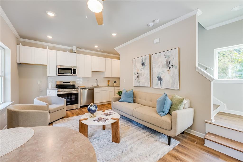 958 Lawton Street Southwest Atlanta, GA 30310 - Photo 2 of 16 a living room with furniture a rug kitchen view and a window