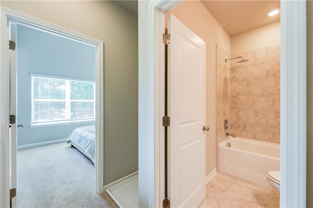 958 Lawton Street Southwest Atlanta, GA 30310 - Photo 6 of 16 a bathroom with a tub shower and a sink