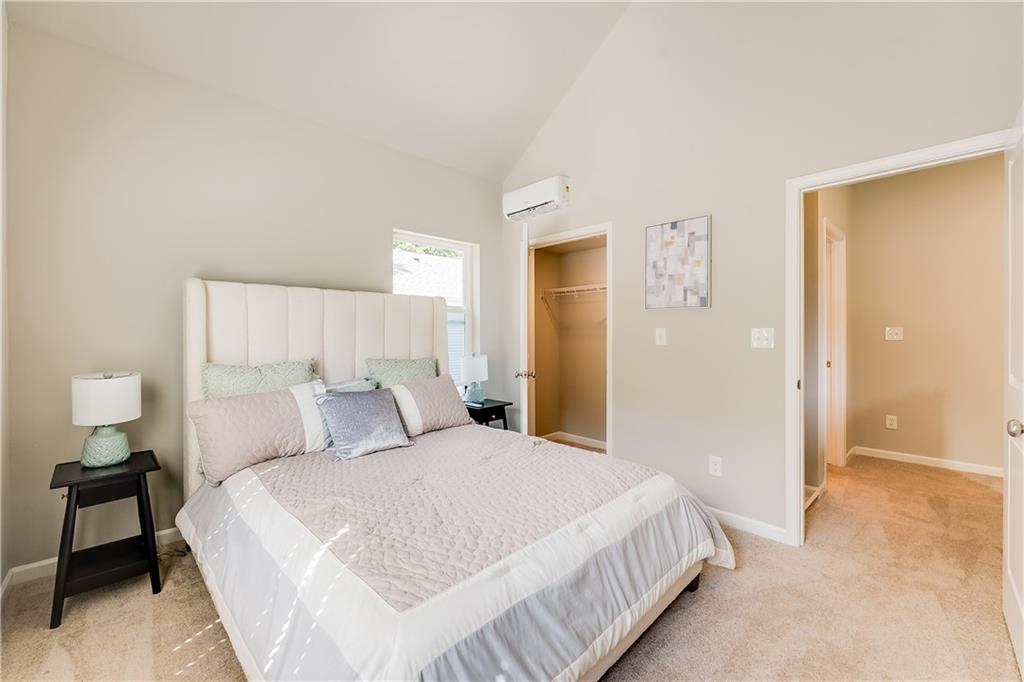 958 Lawton Street Southwest Atlanta, GA 30310 - Photo 10 of 16 a bedroom with a bed and a lamp