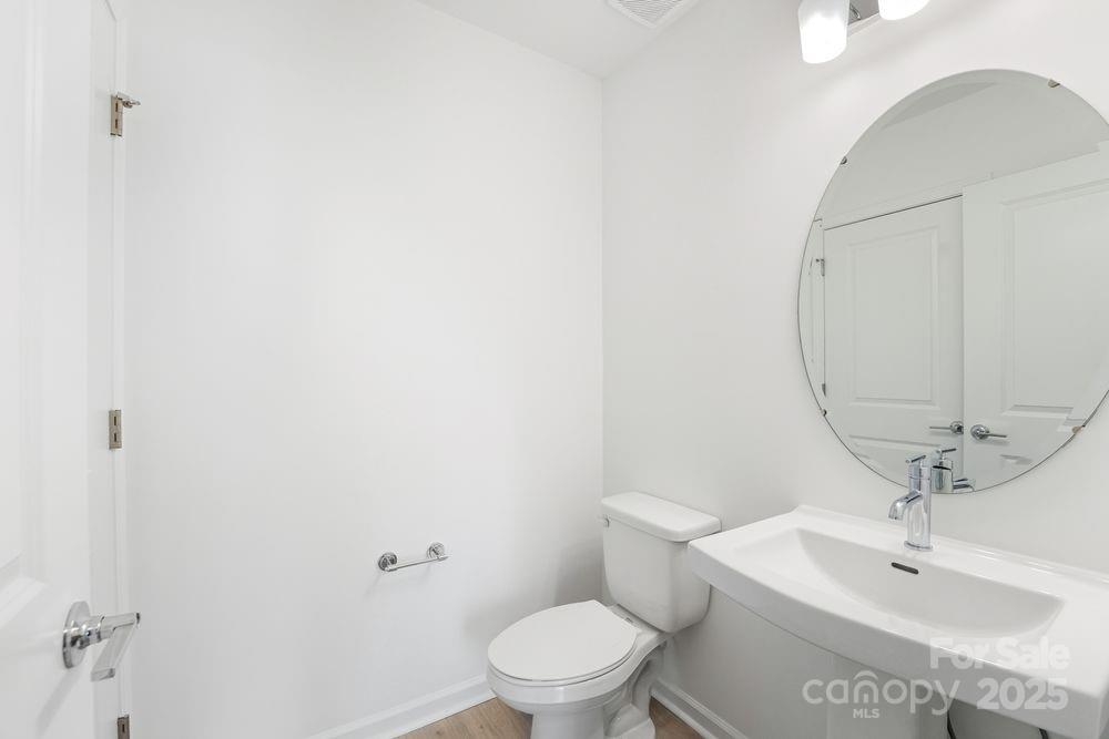 8662 Miles Gap Road Indian Land, SC 29707 - Photo 11 of 31 a bathroom with a sink a toilet and a mirror