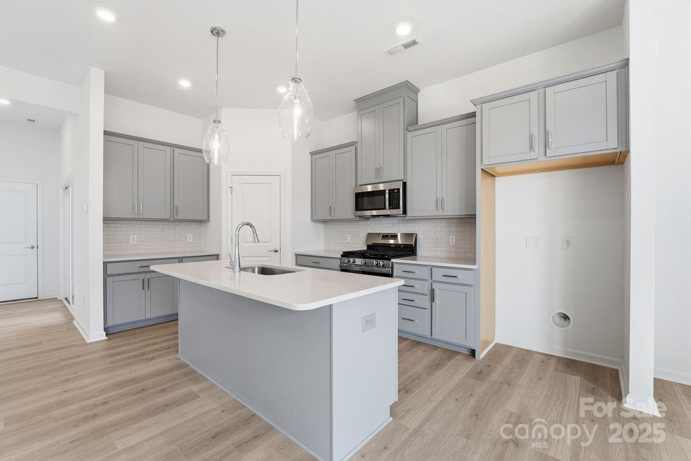 8662 Miles Gap Road Indian Land, SC 29707 - Photo 3 of 31 a kitchen with white cabinets and white appliances
