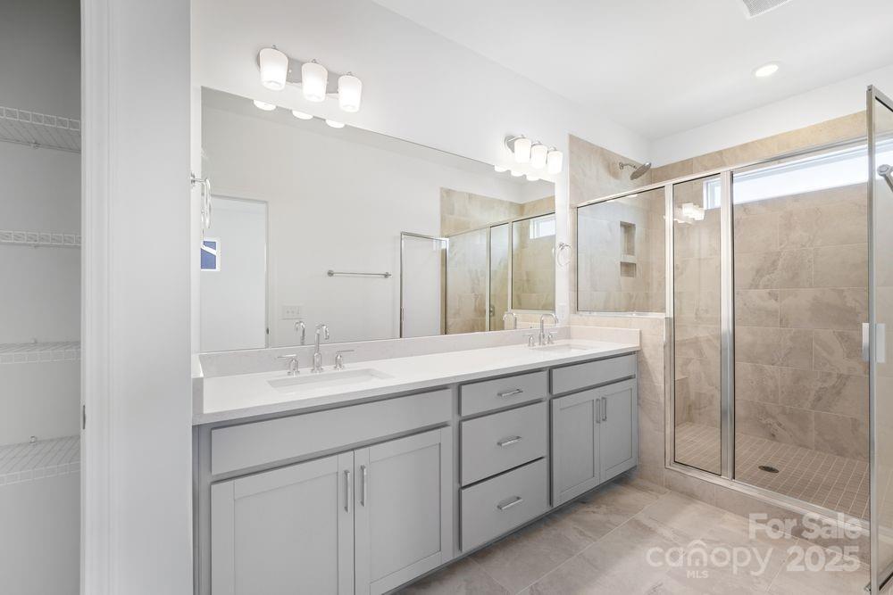 8662 Miles Gap Road Indian Land, SC 29707 - Photo 7 of 31 a bathroom with a shower sink and mirror