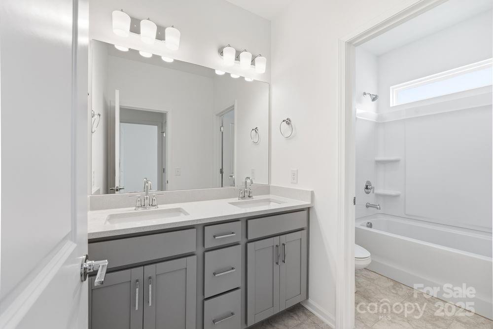 8662 Miles Gap Road Indian Land, SC 29707 - Photo 10 of 31 a bathroom with a sink double vanity granite tub and shower