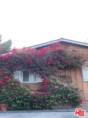 a view of a house with a yard and a garden
