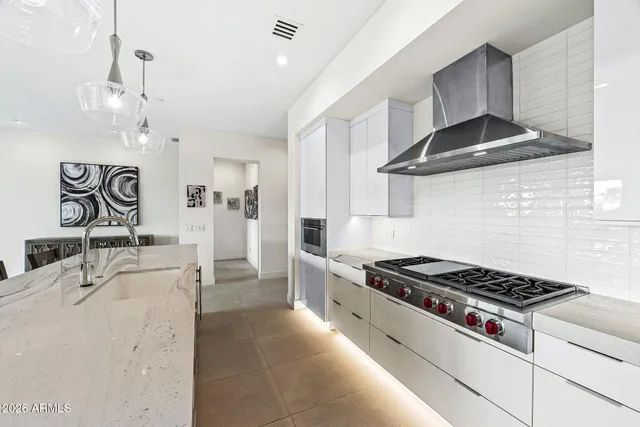 a white stove top oven sitting inside of a kitchen