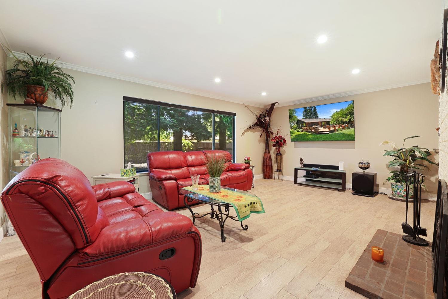 5348 Shippee Lane Stockton, CA 95212 - Photo 14 of 35 a living room with furniture a flat screen tv and a large window