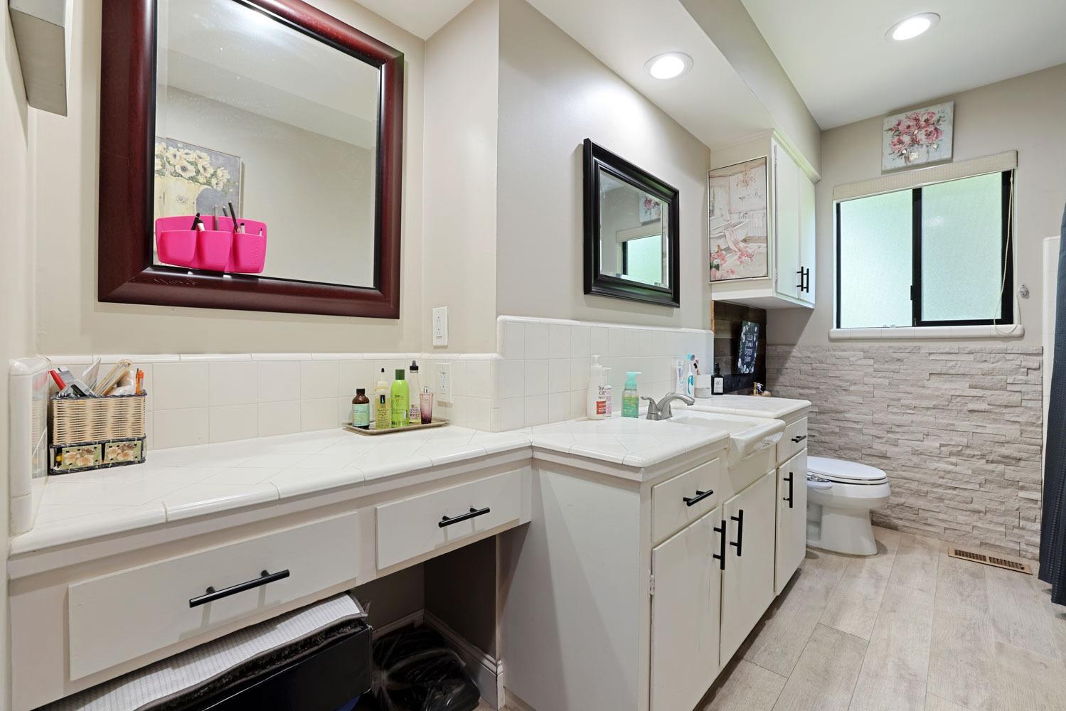 5348 Shippee Lane Stockton, CA 95212 - Photo 16 of 35 a bathroom with a toilet sink and mirror