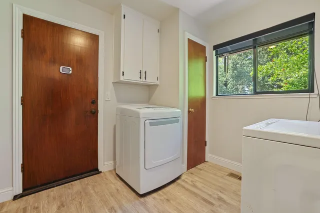 a view of washer and dryer with kitchen view
