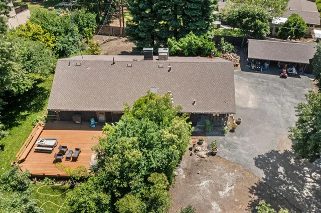 an aerial view of a house with yard swimming pool and outdoor seating