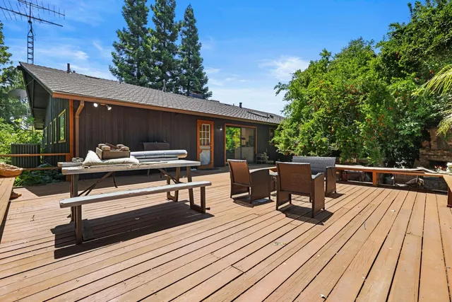 a view of a roof deck with couches and wooden floor