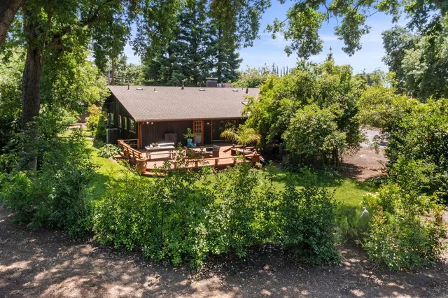 a view of a patio with table and chairs and potted plants