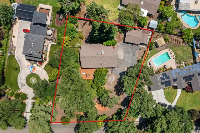 an aerial view of residential house with outdoor space and swimming pool