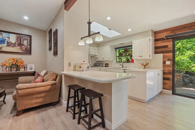 a kitchen with a sink cabinets and window