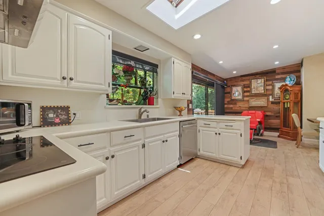 a kitchen that has a sink and a stove in it