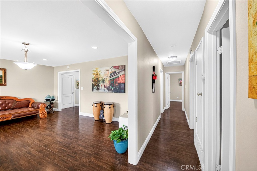 15243 Crosswood Road La Mirada, CA 90638 - Photo 13 of 44 a hallway with wooden floor and furniture