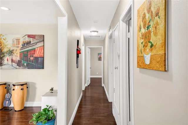 a view of a hallway with wooden floor and stairs