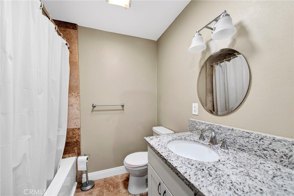 15243 Crosswood Road La Mirada, CA 90638 - Photo 22 of 44 a bathroom with a granite countertop sink and a mirror