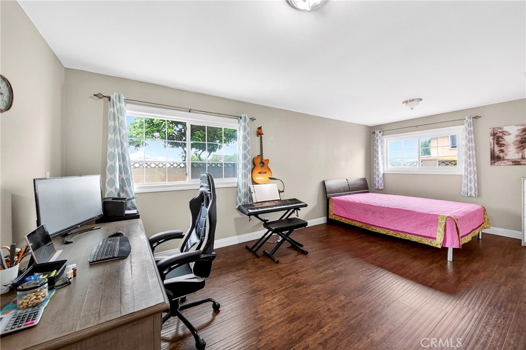 15243 Crosswood Road La Mirada, CA 90638 - Photo 23 of 44 a bedroom with a bed and wooden floor