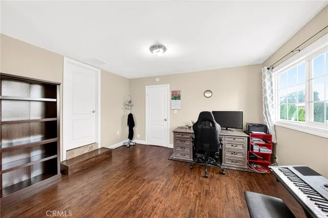 a livingroom with workspace and a window