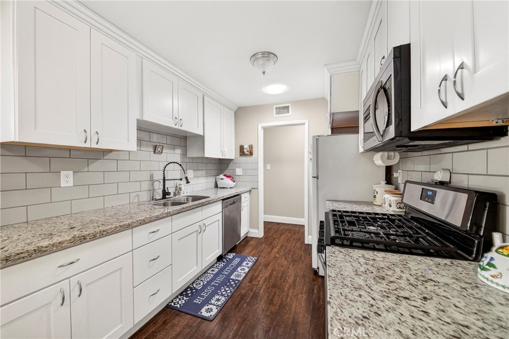 15243 Crosswood Road La Mirada, CA 90638 - Photo 28 of 44 a kitchen with sink stove and refrigerator