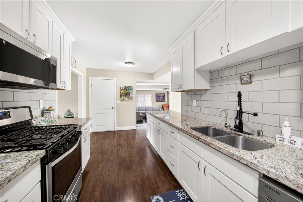 15243 Crosswood Road La Mirada, CA 90638 - Photo 30 of 44 a kitchen with granite countertop a sink and a stove top oven