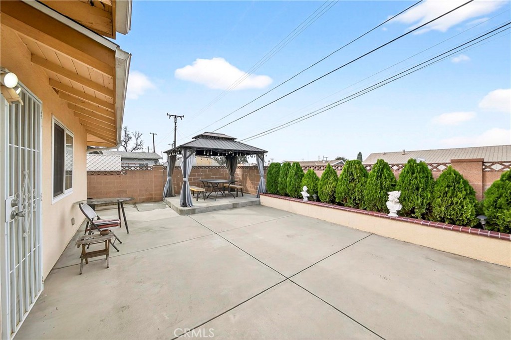 15243 Crosswood Road La Mirada, CA 90638 - Photo 40 of 44 a view of a patio with table and chairs potted plants with wooden fence
