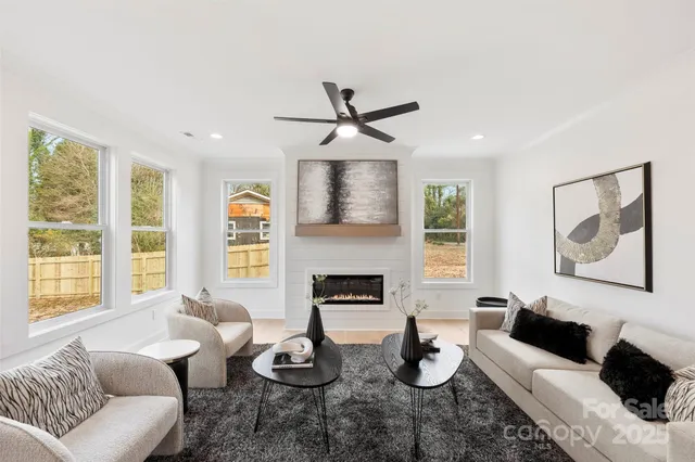 a living room with furniture fireplace and window